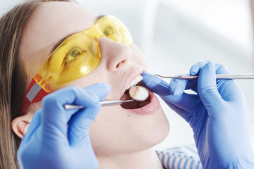 Naklejka premium Examination of a patient at a dentist office, using a dental tool.
