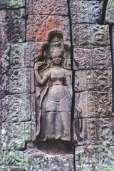 Apsara sculpture on the wall of the temple in Angkor.