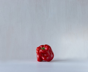 Ugly shaped organic vegetables. Deformed homegrown bell pepper isolated on white background.