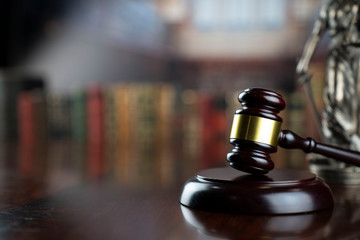 Law and justice theme.  Gavel of  the judge on court library background.