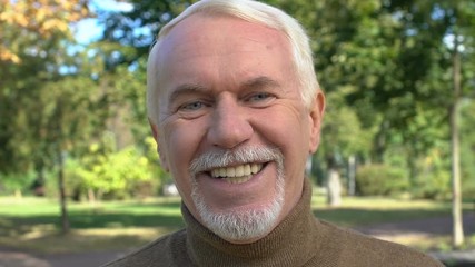 Happy aged male smiling on camera, positive retired man, dental care, enjoyment