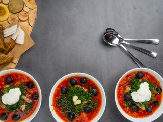Traditional Ukrainian Russian borscht with olives, dill, garlic, lard on the bowls. Beetroot soup Top view. Traditional Ukraine food cuisine