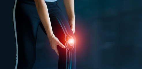 Sport woman suffering from pain in knee. Tendon problems and Joint inflammation on dark background....