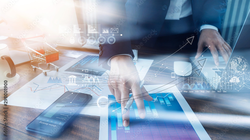 Aufkleber Businessman analyzing sales data and economic growth and pointing at business report document with icon and graph financial, marketing, online banking and payment, business planning and strategy.