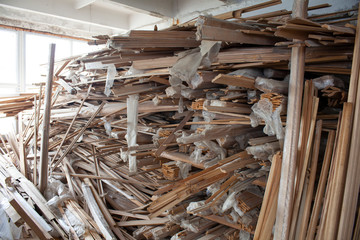 Dump of broken boards. Unnecessary trash. The removed floors are piled in a heap.