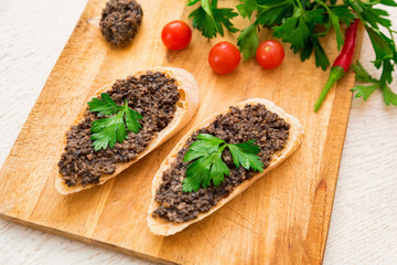 Fresh tasty bruschetta with truffle sauce, parsley and tomates. Top view