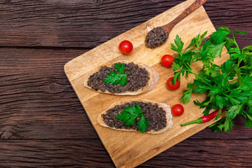 Fresh tasty bruschetta with truffle sauce, chili, parsley and tomates. Top view