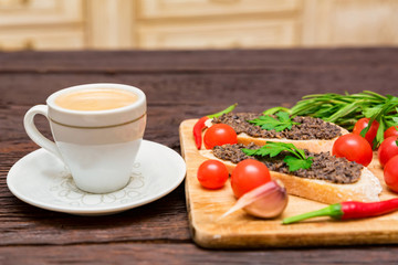 Fototapeta na wymiar Fresh tasty bruschetta with truffle sauce, parsley, tomates and cup of coffee