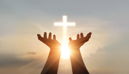 Man hands palm up praying and worship of cross, eucharist therapy bless god helping, hope and faith, christian religion concept on sunset background. - obrazy, fototapety, plakaty