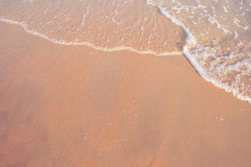 Top view.Sandy beach with wave foam.