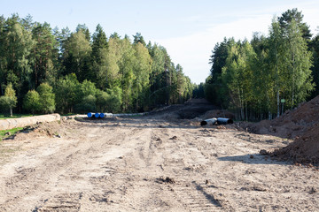 The laying of the pipeline. A clearing through the forest is cut down for laying gas pipes. The work of heavy equipment has changed the landscape. Oil business in action. © Олег Копьёв