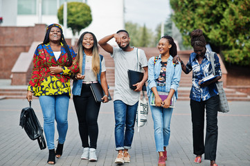 Fototapeta premium Group of five african college students spending time together on campus at university yard. Black afro friends studying. Education theme.