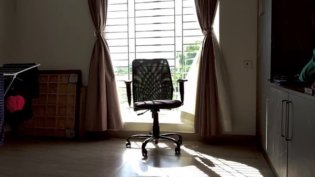 A chair against in window light.