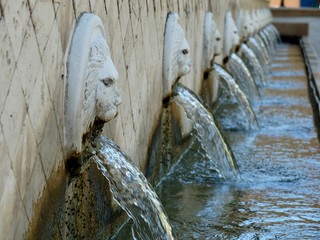 Stone fountains with faces spouting water