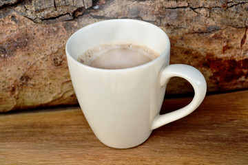 White coffee cup Placed on old wooden floors and natural backgrounds.