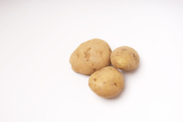Fototapeta na wymiar Three fresh brown potatoes raw isolated white background
