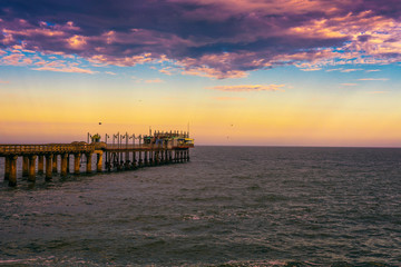 Sunset over the old historic jetty in Swakopmund, Namibia