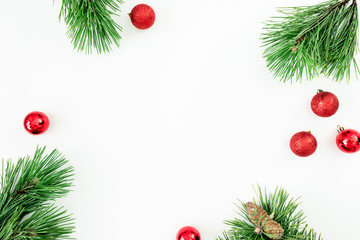 Naklejka na ściany i meble Christmas frame of evergreen tree branches and balls decoration on white background. Flat lay