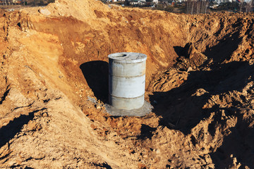 Construction site concrete well for water pipes