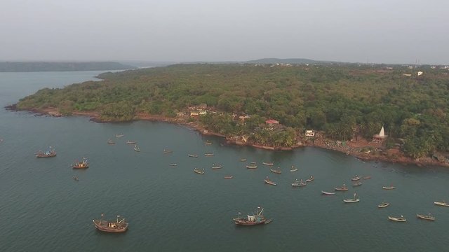 drone pan shot of  fishing boats in a small port