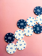 Poker chips on a pink background. Place for text. Gambling.