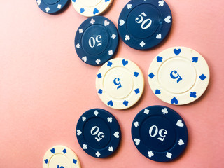 Poker chips on a pink background. Place for text.