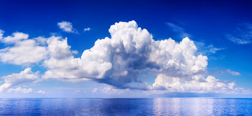 White cumulus clouds in blue sky over sea landscape, big cloud above ocean water panorama, horizon, beautiful tropical sunny summer day seascape panoramic view, cloudy weather, cloudscape, copy space