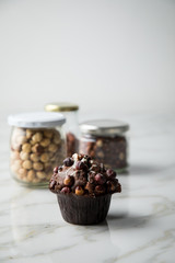 Haselnuss Muffin mit  Walnüssen und Haselnüssen in Vorrat Gläser auf Marmor Tisch hell Hintergrund