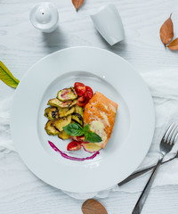 fried fish with vegetables in the plate