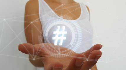Woman on blurred background using digital hashtag