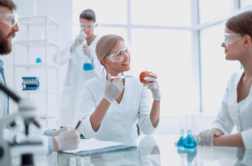 Food quality control. a group of scientists testing the fruit