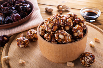 Vegan delicious sweet cocoa and almond balls on wooden table healthy food