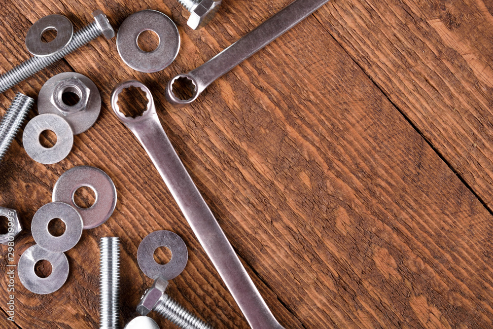 Sticker Keys wrenches, bolts, nuts, washers on a wooden background