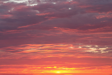 Naklejka na ściany i meble Bright dramatic sky with clouds during sunrise or sunset