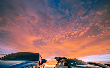 Car parked at outdoor car parking lot of campsite with beautiful sunset sky. Car drive for...