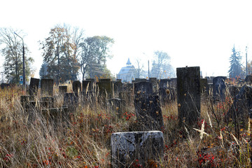 An old cluttered Jewish cemetery with uneven tombstones carved in Hebrew is a preserved story.
