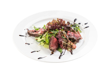 Spicy roast beef Salad with green mix and balsamic sauce isolated on white background