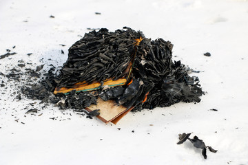 burning book in  snow. pages with the text in  open book burn with  bright flame.