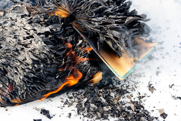 burning book in  snow. pages with the text in  open book burn with  bright flame.