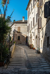 Fototapeta na wymiar Old buildings on small italian street. Narrow street in Italy.