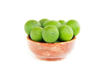 green fresh natural tangerines oranges in a brown plate