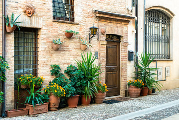 Fototapeta na wymiar Old buildings on small italian street. Narrow street in Italy.