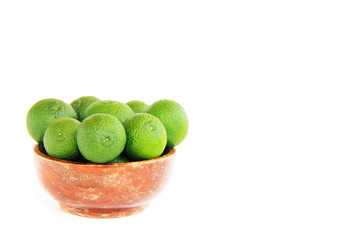 green fresh natural tangerines oranges in a brown plate