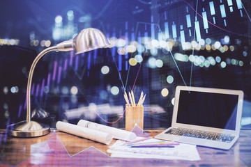 Stock market graph on background with desk and personal computer. Multi exposure. Concept of financial analysis.