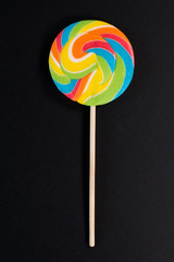 Swirl round lollipop on black background. concept of unhealthy food,sweets and candy day