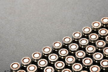 Group of bullets on gray stone texture with copy space