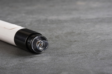 Facial skin cleaning machine on gray stone texture with copy space
