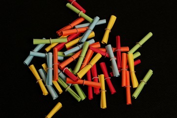 A pile of colorful raffle loosely lying on a black background