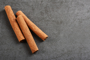 Cinnamon sticks on the gray stone texture with copy space	
