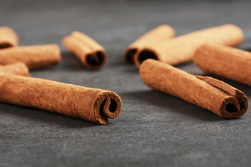 Cinnamon sticks on the gray stone texture with copy space	